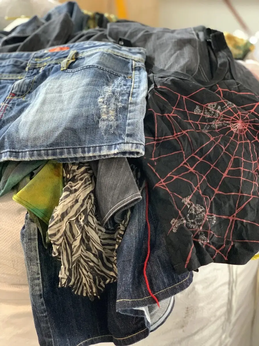 Vintage wholesale clothing on a rack, including Euro Y2K pieces.